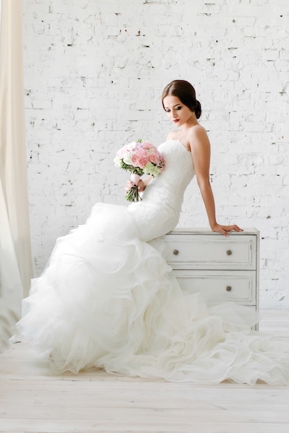 Photo bride in a white dress and holding a bouquet