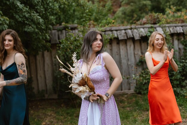 A bride in a white dress throws a wedding bouquet