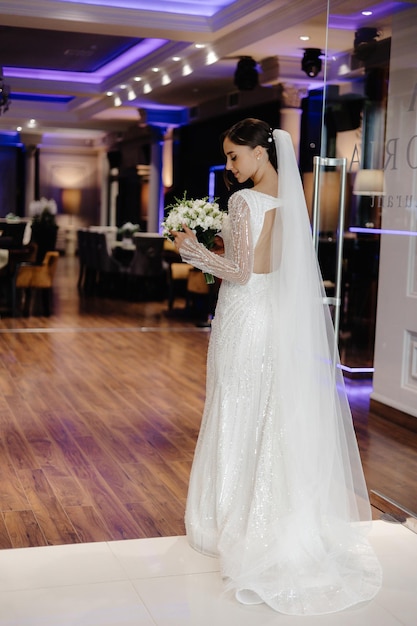 a bride in a white dress with a bouquet of flowers