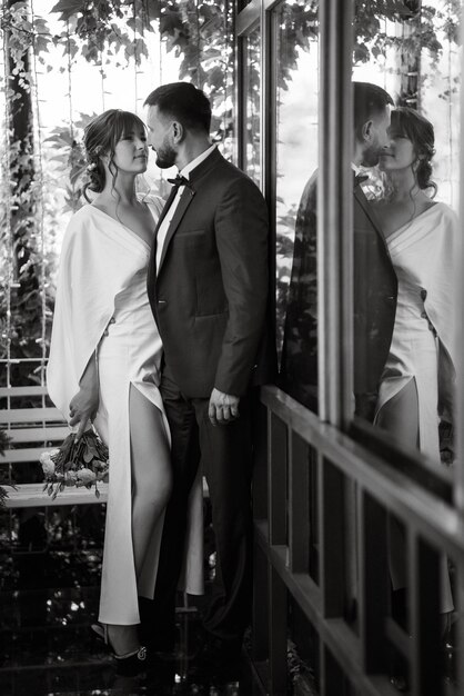 Photo bride in a white dress with a bouquet and the groom in a blue suit