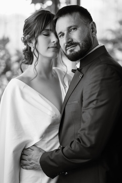 Bride in a white dress with a bouquet and the groom in a blue suit