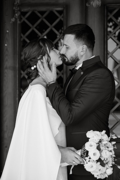 Bride in a white dress with a bouquet and the groom in a blue suit