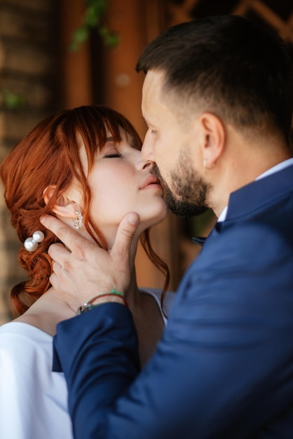 Bride in a white dress with a bouquet and the groom in a blue suit