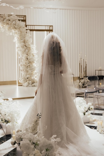 Foto sposa in un abito lungo da sposa elegante bianco