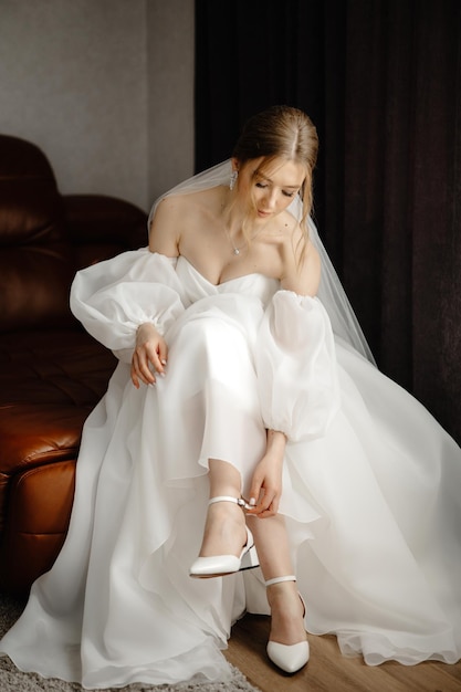 the bride in a white wedding dress is wearing shoes