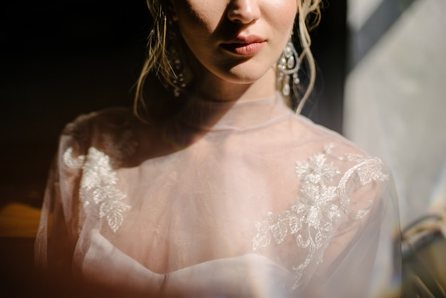 Bride in white wedding dress posing indoors