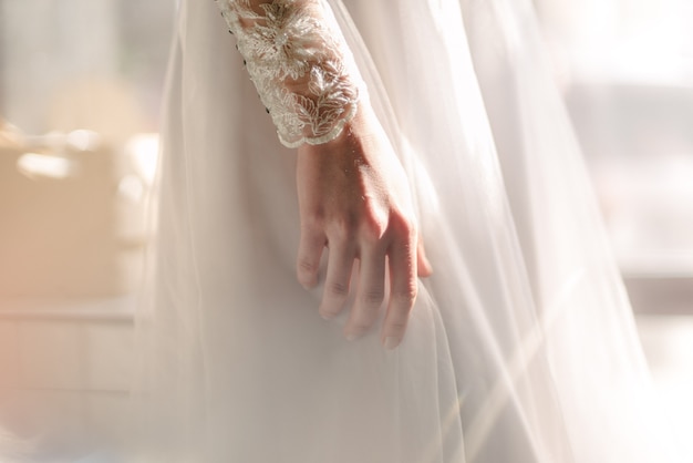 Bride in white wedding dress posing indoors