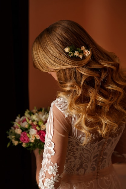 Bride with bouquet and wedding hairstyle