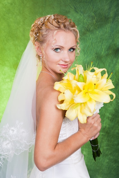 Bride with a bouquet of yellow lilies.