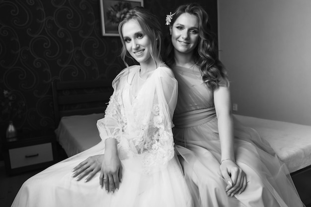 Bride with bridesmaids in a room on the wedding day