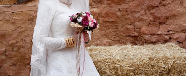 Sposa con braccialetti d'oro e bouquet