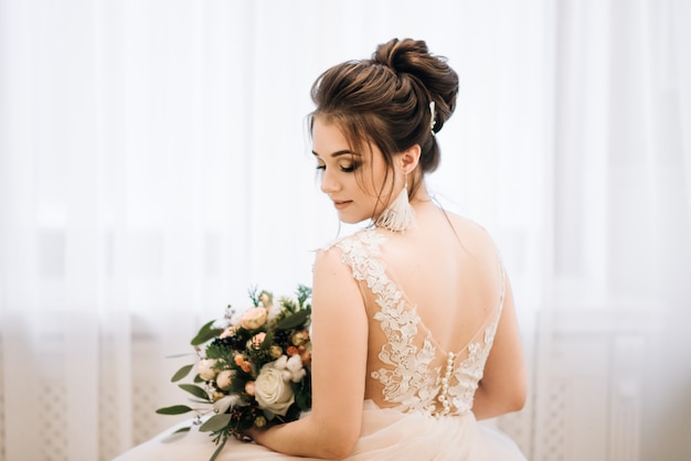 Bride with luxurious hairstyle and make up in the morning