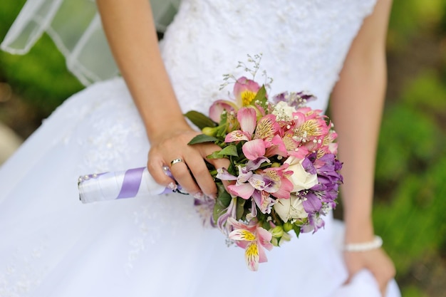 Bride with wedding bouquet closeup