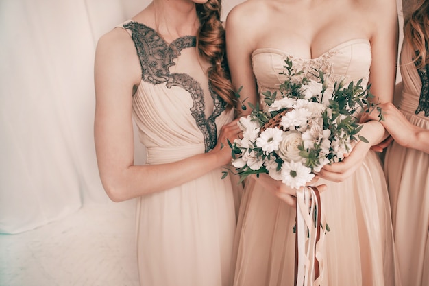 bride with a wedding bouquet standing with her friends.