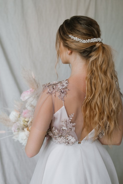 Bride with wedding dress and bouquet