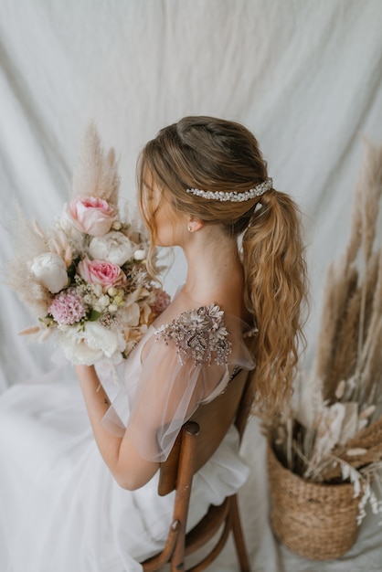 Bride with wedding dress and bouquet