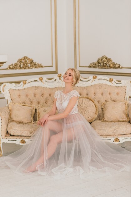 bride with wedding dress sitting in room