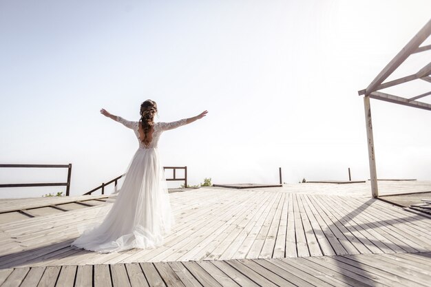 Bride woman in a white dress outdors