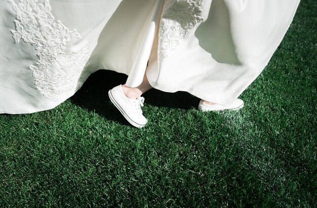 brides feet the bride plays football closeup of the brides feet in sneakers running across the