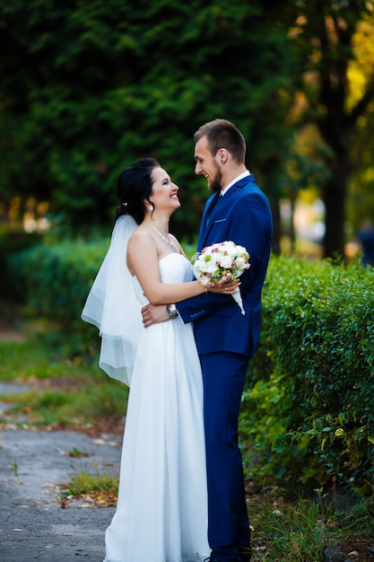 Brides in full growth in a summer park