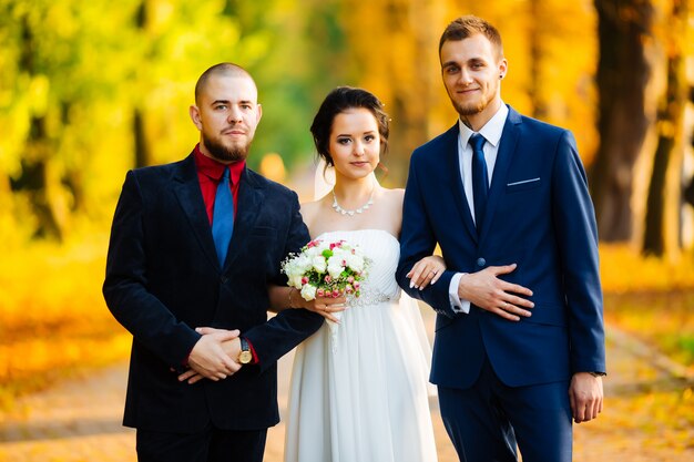 Brides and their friends are walking in the garden