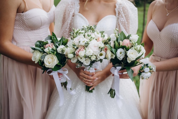 Brides wedding shoes with a bouquet with roses and other flowers on tha arm chair