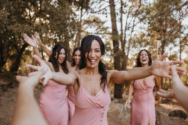 Bridesmaids in pretty dresses celebrating