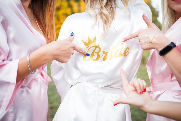 Photo bridesmaids show on the inscription on the dressing gown of the bride.