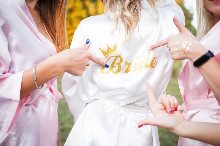 Photo bridesmaids show on the inscription on the dressing gown of the bride.