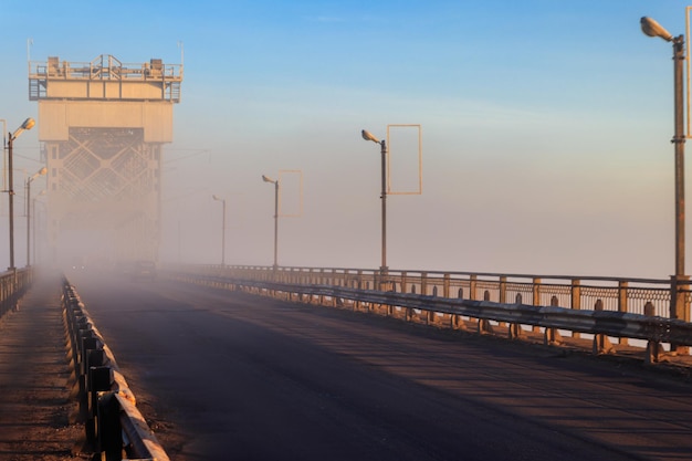 Bridge across river Dnieper in fog in the morning at autumn Kremenchug Ukraine