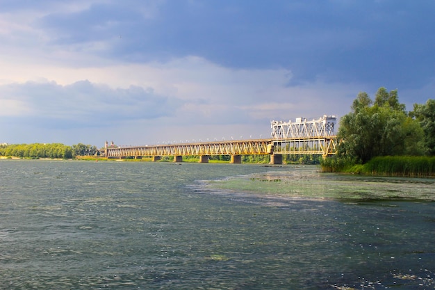 Bridge across river Dnieper and storm clouds in sky