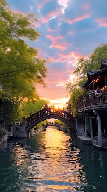 bridge over a canal with a beautiful sunset