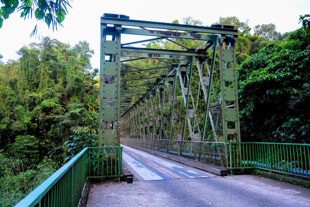 Bridge over empty road against sky