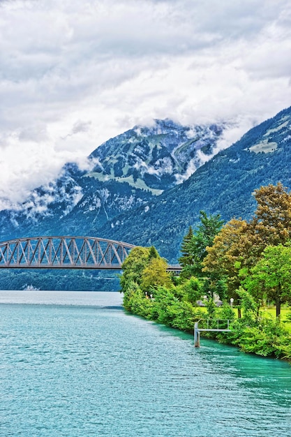 Bridge over Lake Brienz and Brienzer Rothorn mountain on the background at Interlaken in Canton of Bern in Switzerland