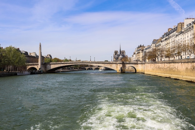 Bridge pont de la tournelle across seine river and beautiful historic buildings of paris france