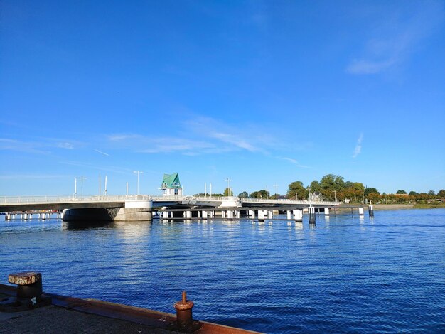 Bridge over river against blue sky