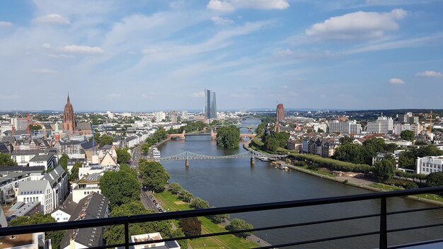 Bridge over river against buildings in city