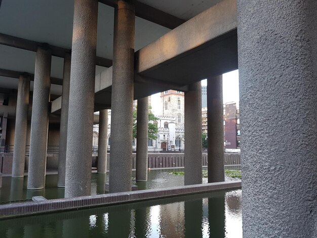 Bridge over river against buildings in city