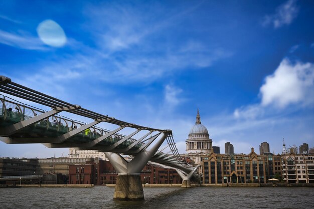 Bridge over river against buildings in city