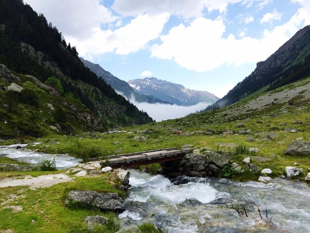 Bridge over river against mountains