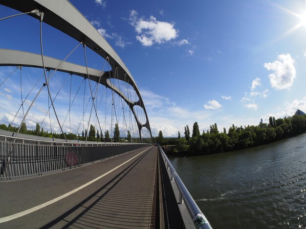 Photo bridge over river against sky in city