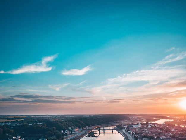 Bridge over river against sky during sunset