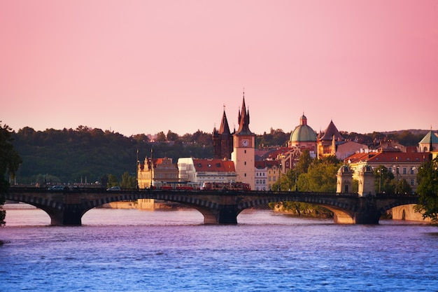 Bridge over river in city against clear sky