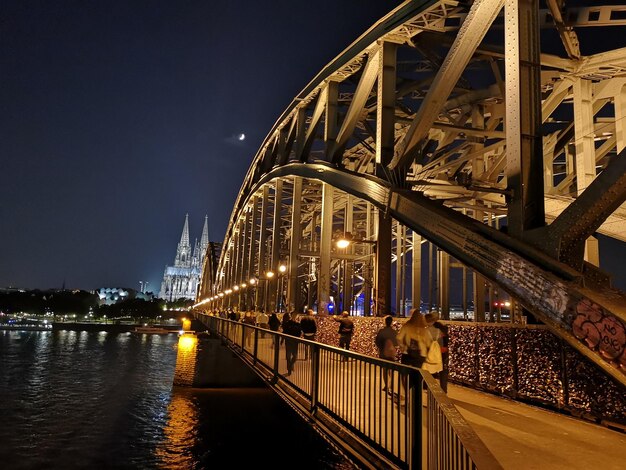 Bridge over river in city at night