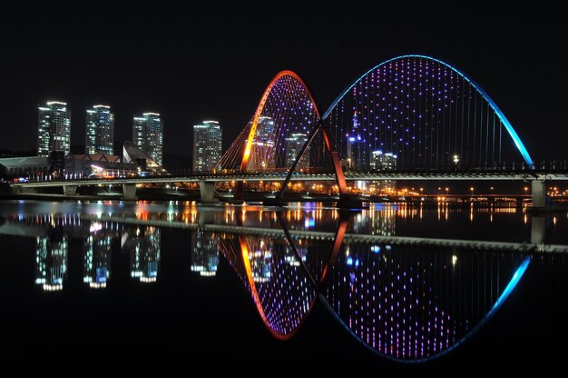 Photo bridge over river at night