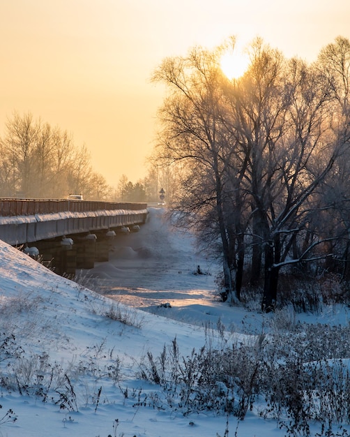 The bridge over the river on a winter evening