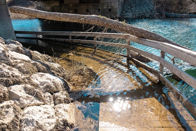 A bridge over a river with a bridge in the background