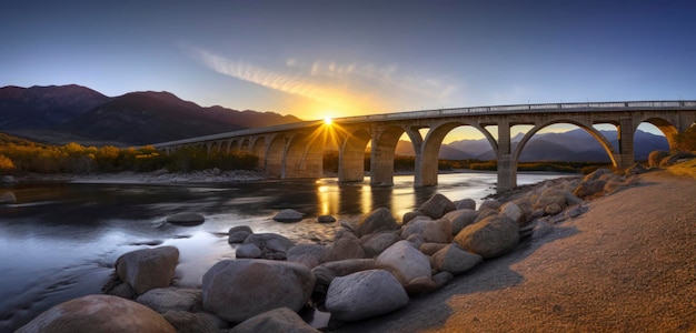 Photo a bridge over a river with the sun setting behind it