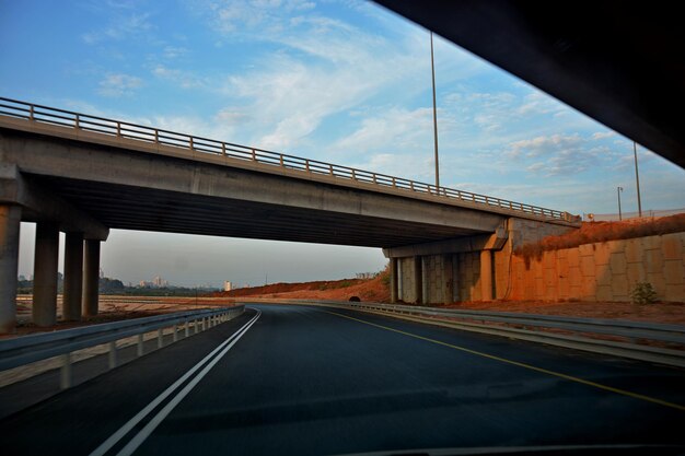 Bridge over road against sky