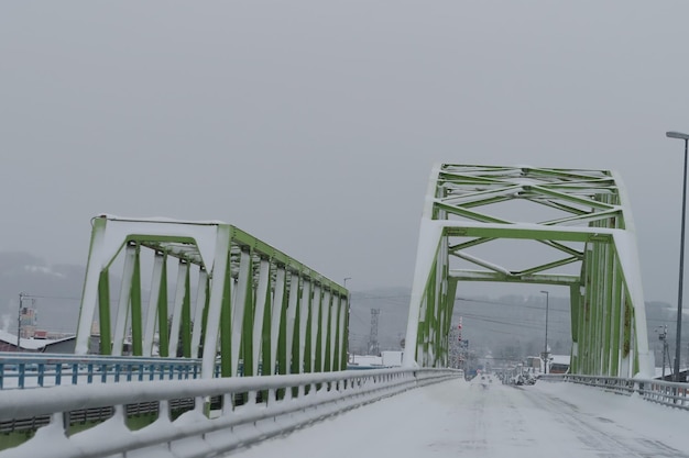 Bridge over road in city against sky during winter